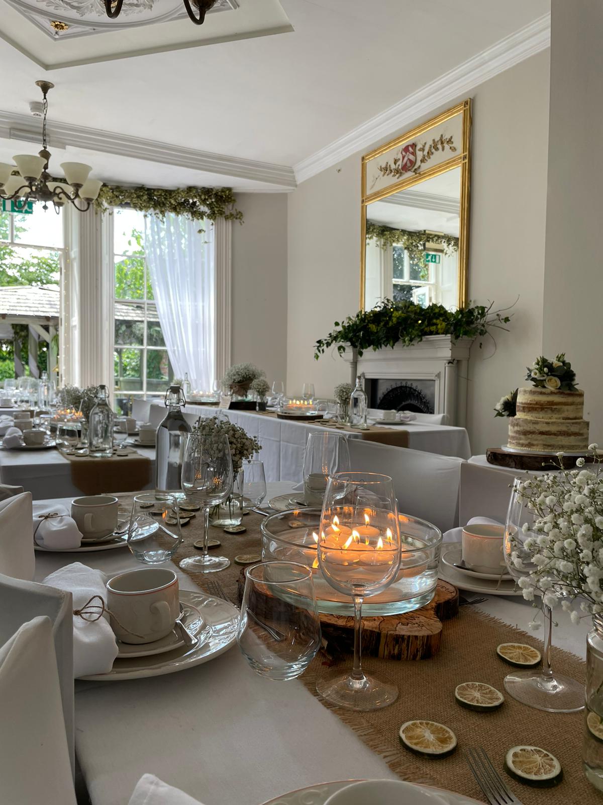 Candlelit wedding table detail with naked wedding cake at The Silk House